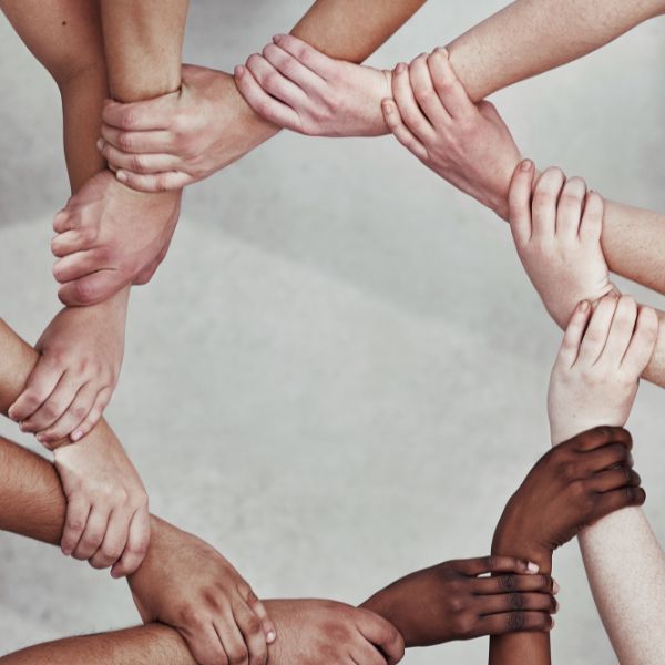 Diverse hands forming a connected circle symbolizing unity and support